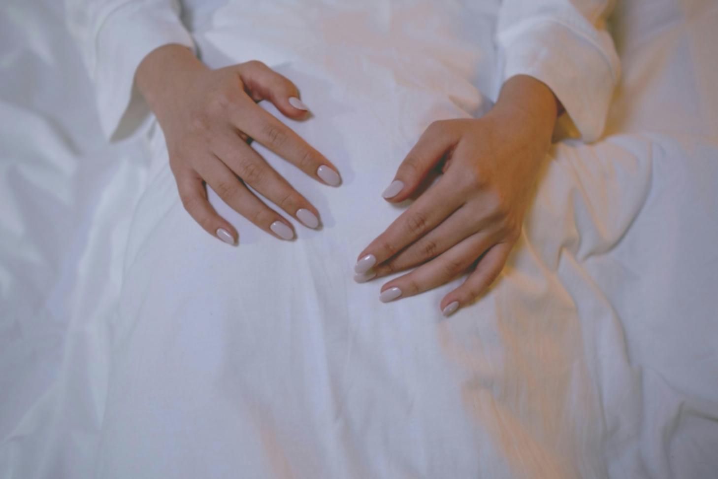 Skilled nail technician applying polish with precision